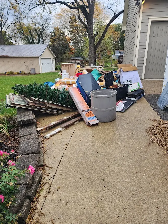 Dumpster being loaded with debris for Estate Cleanout Dumpster Rental in Greenacres